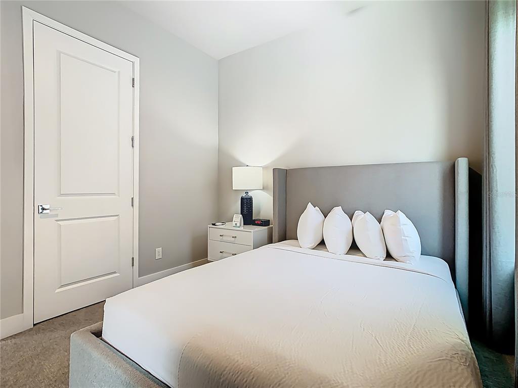 7740 Sandy Ridge Drive, Unit 245 Reunion, FL 34747 - Photo 46 of 57 a bedroom with a bed and a night stand