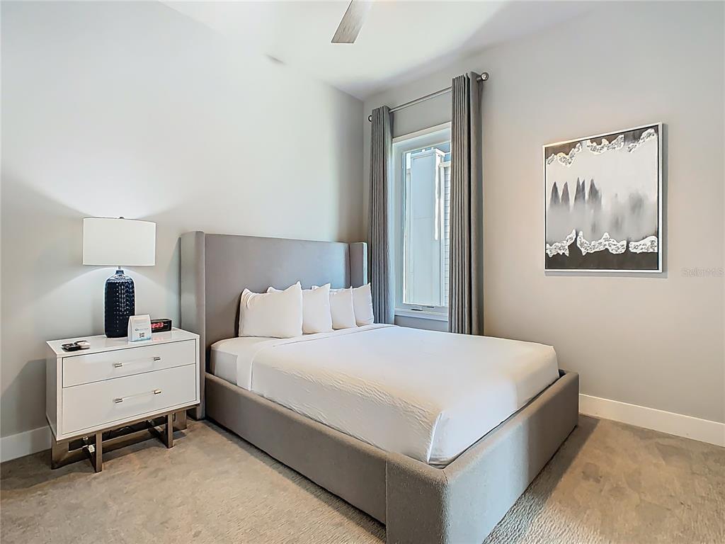 7740 Sandy Ridge Drive, Unit 245 Reunion, FL 34747 - Photo 47 of 57 a bedroom with a bed and lamp