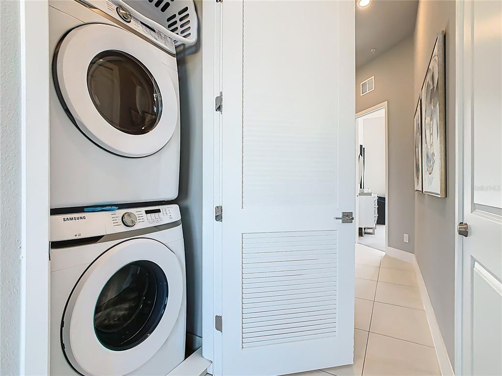 7740 Sandy Ridge Drive, Unit 245 Reunion, FL 34747 - Photo 49 of 57 a view of a hallway with washer and dryer