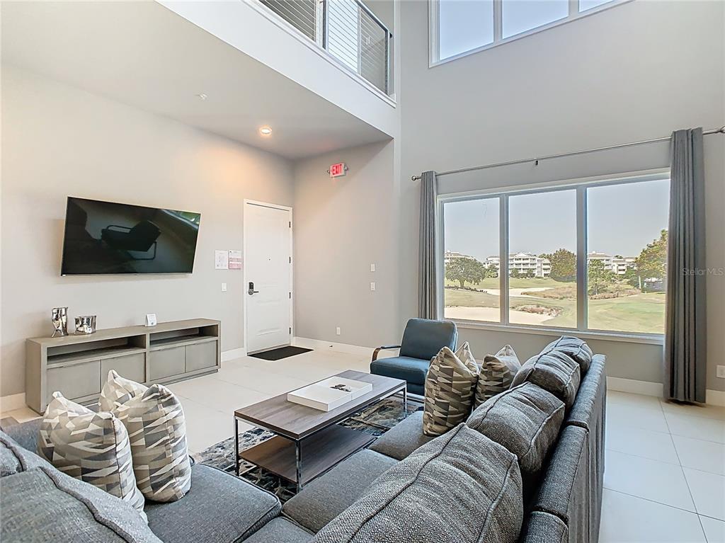 7740 Sandy Ridge Drive, Unit 245 Reunion, FL 34747 - Photo 6 of 57 a living room with furniture and a flat screen tv