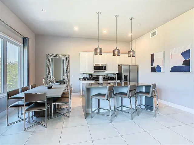 a kitchen with stainless steel appliances granite countertop a sink a stove top oven a counter space and cabinets