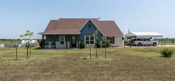 a house with lots of trees in front of it