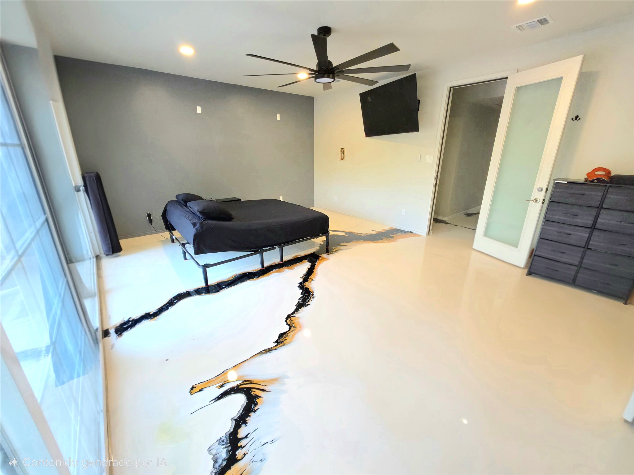 2201 Teri Road Austin, TX 78744 - Photo 12 of 40 Custom epoxy flooring elevates this modern bedroom featuring sliding glass doors and recessed lighting.