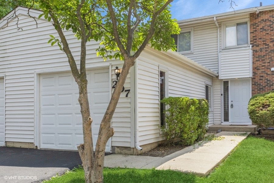 a front view of a house with garden