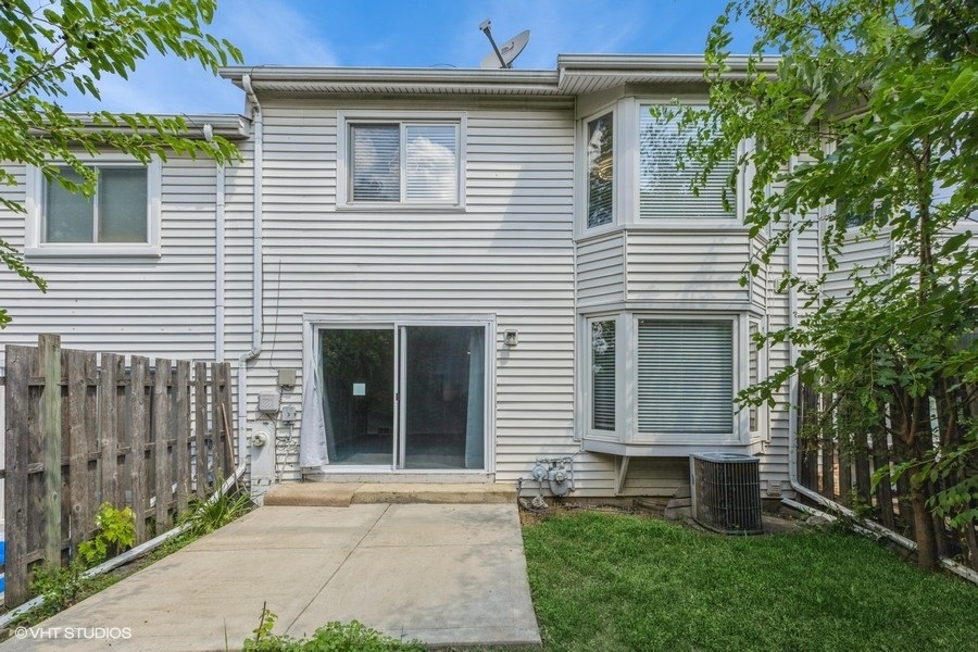 207 Walker Drive Bolingbrook, IL 60440 - Photo 17 of 18 a view of a house with a yard and a large window