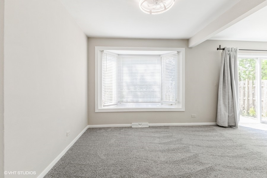 207 Walker Drive Bolingbrook, IL 60440 - Photo 8 of 18 an empty room with windows