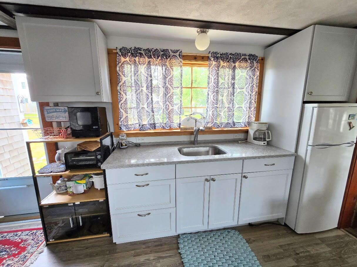 18 Myrtle Lane Dennis Port, MA 02639 - Photo 8 of 25 a kitchen with stainless steel appliances a sink cabinets and a large window