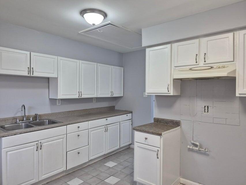 3326 Delaware Street Gary, IN 46409 - Photo 3 of 14 a kitchen with white cabinets and sink