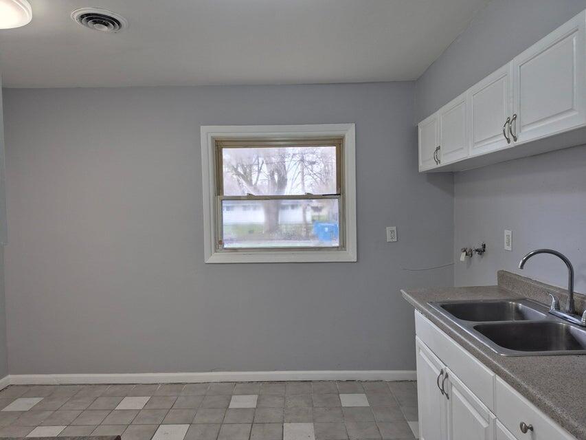 3326 Delaware Street Gary, IN 46409 - Photo 4 of 14 a kitchen with a sink cabinets and window