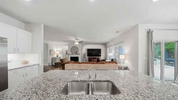 a view of a chairs and table in patio with a barbeque grill and a couch