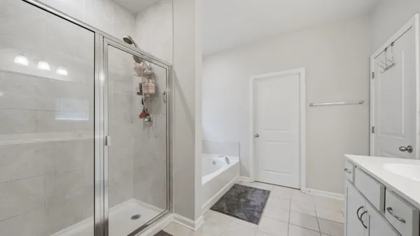 a bathroom with a sink a mirror and a shower