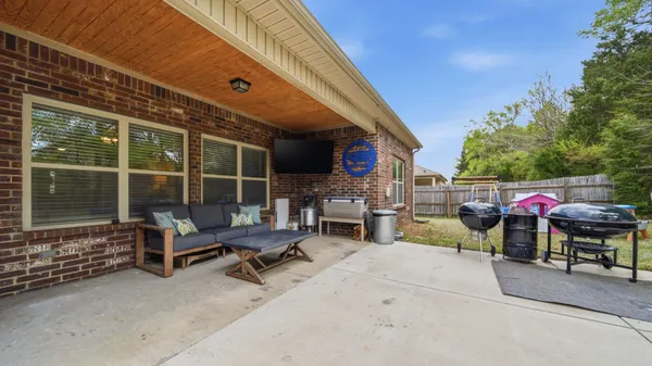 a view of a patio with iron fence