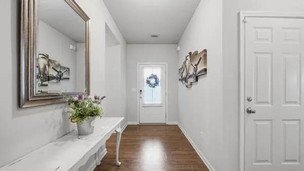 a view of a hallway and wooden floor