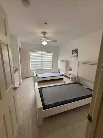 a bedroom with a bed and a large window