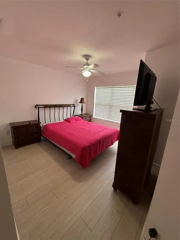 a bedroom with a bed and flat screen tv
