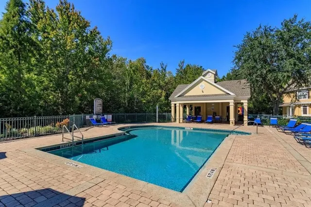 a view of a house with swimming pool and sitting area