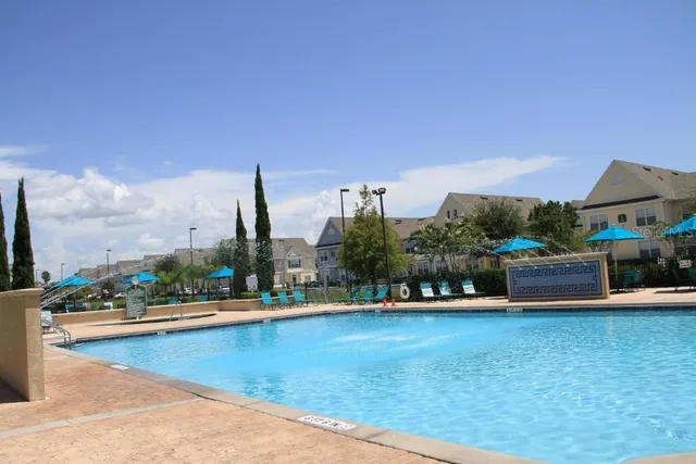 a view of swimming pool with outdoor seating and lake view