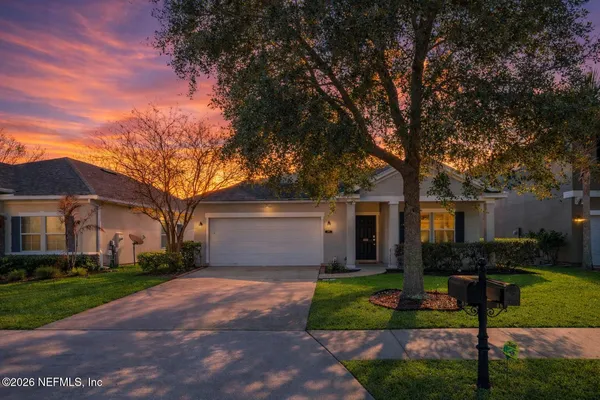 a front view of house with yard and green space