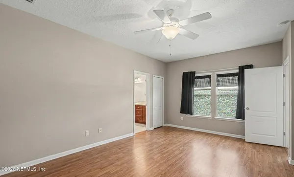 a bedroom with a bed dresser and a window