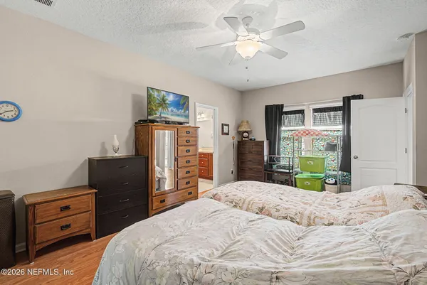 a bathroom with a granite countertop bathtub a double vanity sink a large mirror and a bathtub