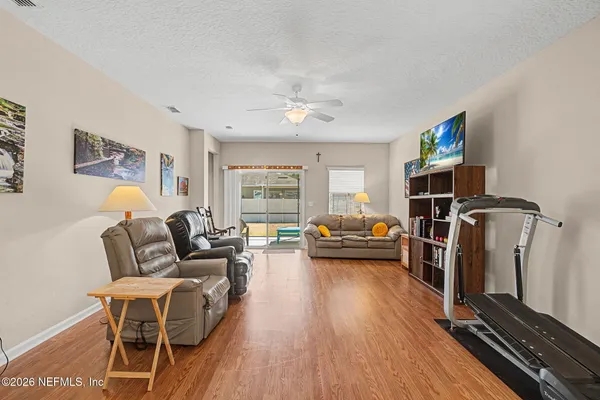 a living room with furniture and wooden floor