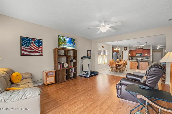 a kitchen with stainless steel appliances kitchen island granite countertop a refrigerator and cabinets