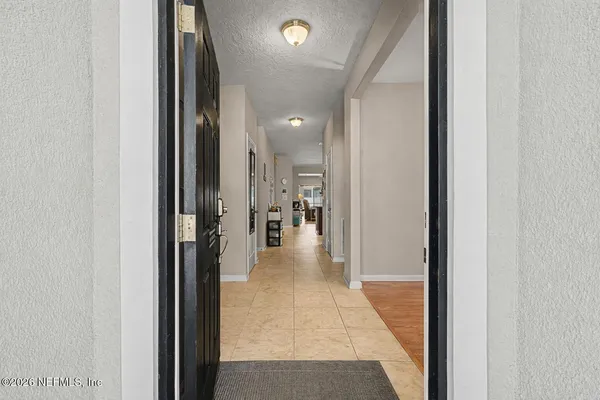 a view of a hallway with dining area