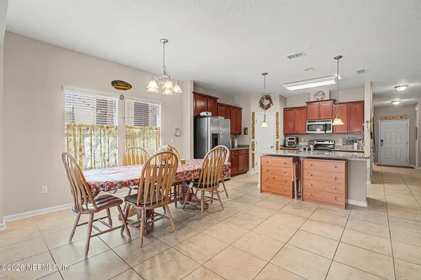a kitchen with stainless steel appliances granite countertop a sink a stove and a refrigerator