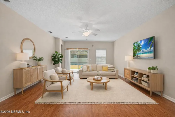 a living room with furniture a window and a flat screen tv