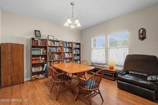 a view of a dining room with furniture window and wooden floor