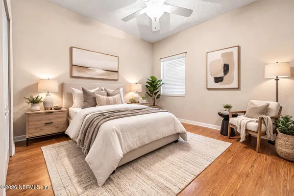 a spacious bedroom with a bed and a chandelier
