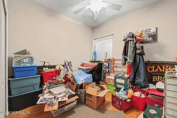 a bedroom with furniture and a chair