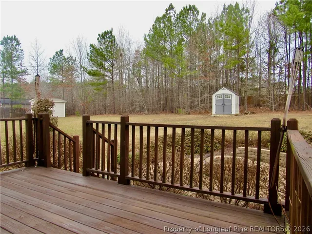 a balcony with wooden floor and fence