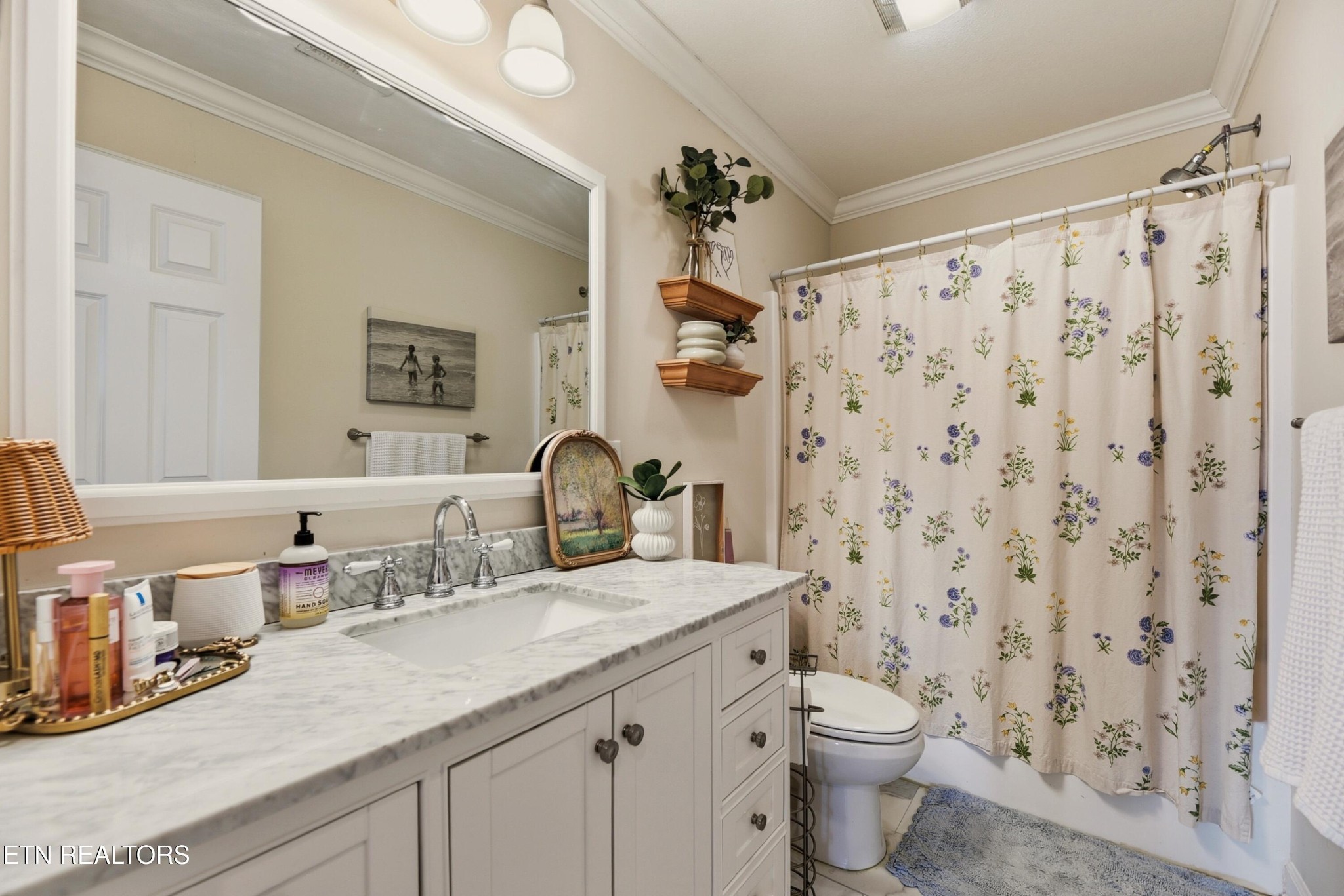 117 Elizabethton Way Clinton, TN 37716 - Photo 29 of 41 a bathroom with a granite countertop sink a toilet and a shower curtain
