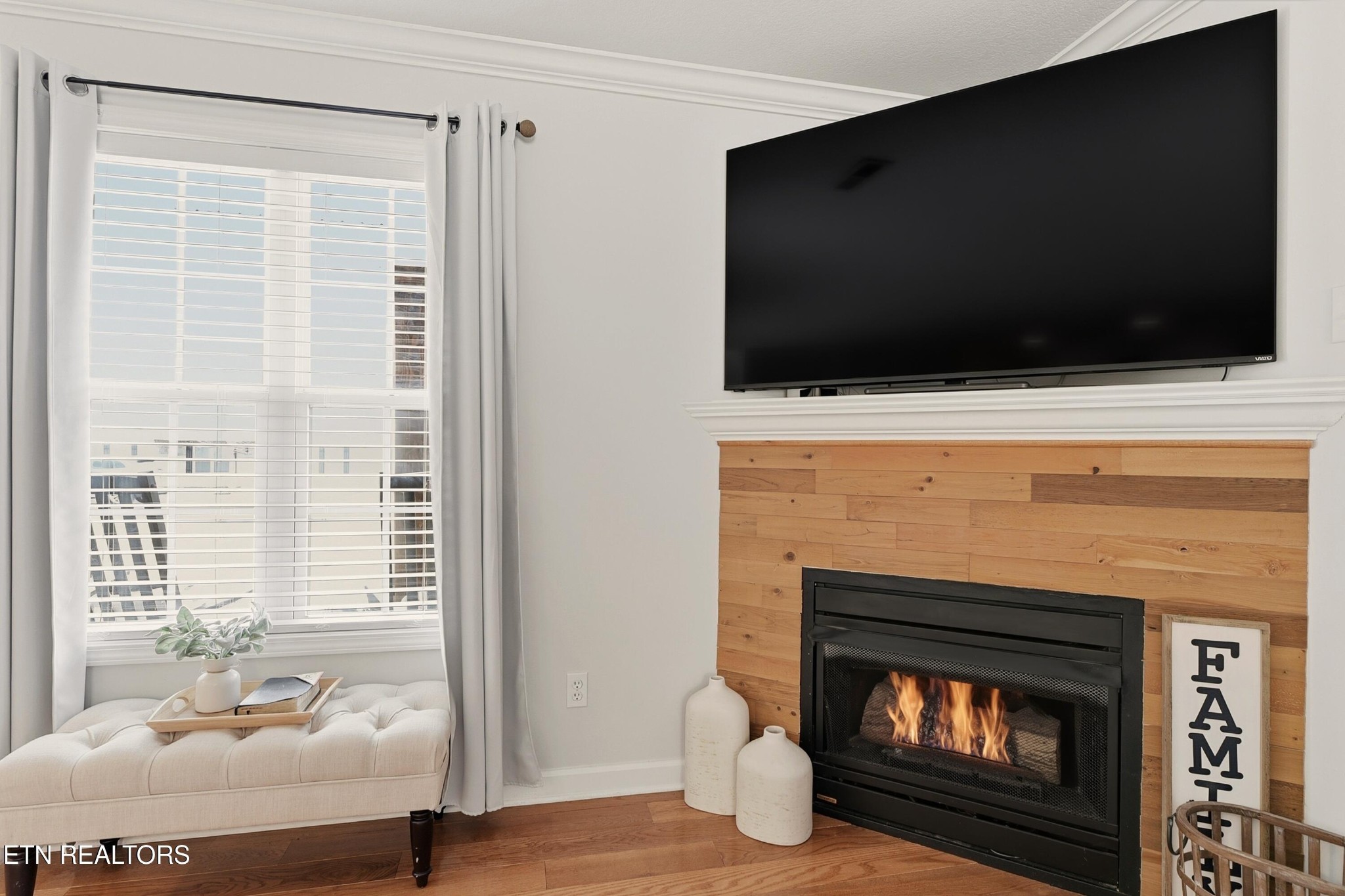 117 Elizabethton Way Clinton, TN 37716 - Photo 8 of 41 a living room with a fireplace a flat screen tv and a window