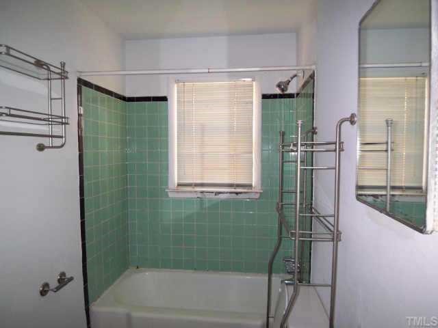 716 Oak Road Raleigh, NC 27603 - Photo 5 of 6 a bathroom with a shower and a window