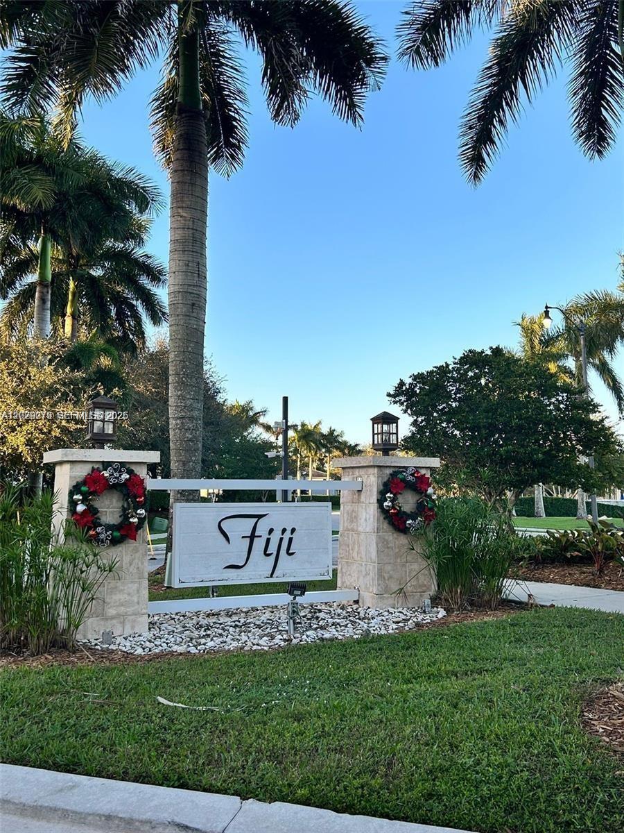 142 Northeast 28th Terrace, Unit 7 Homestead, FL 33033 - Photo 1 of 17 a view of a house with a yard and potted plants