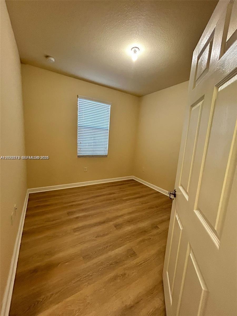 142 Northeast 28th Terrace, Unit 7 Homestead, FL 33033 - Photo 13 of 17 a view of an empty room