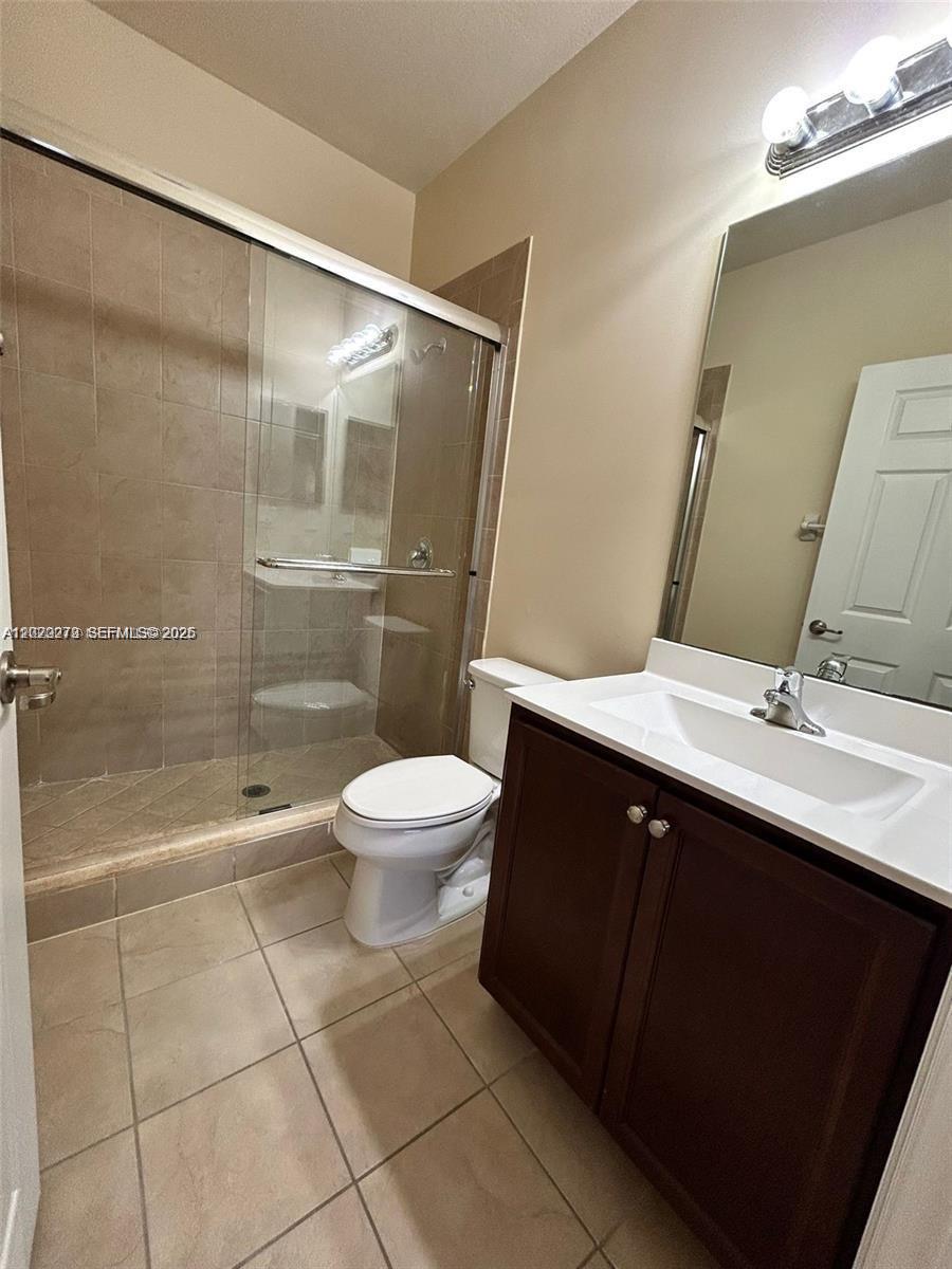 142 Northeast 28th Terrace, Unit 7 Homestead, FL 33033 - Photo 14 of 17 a bathroom with a sink toilet and shower