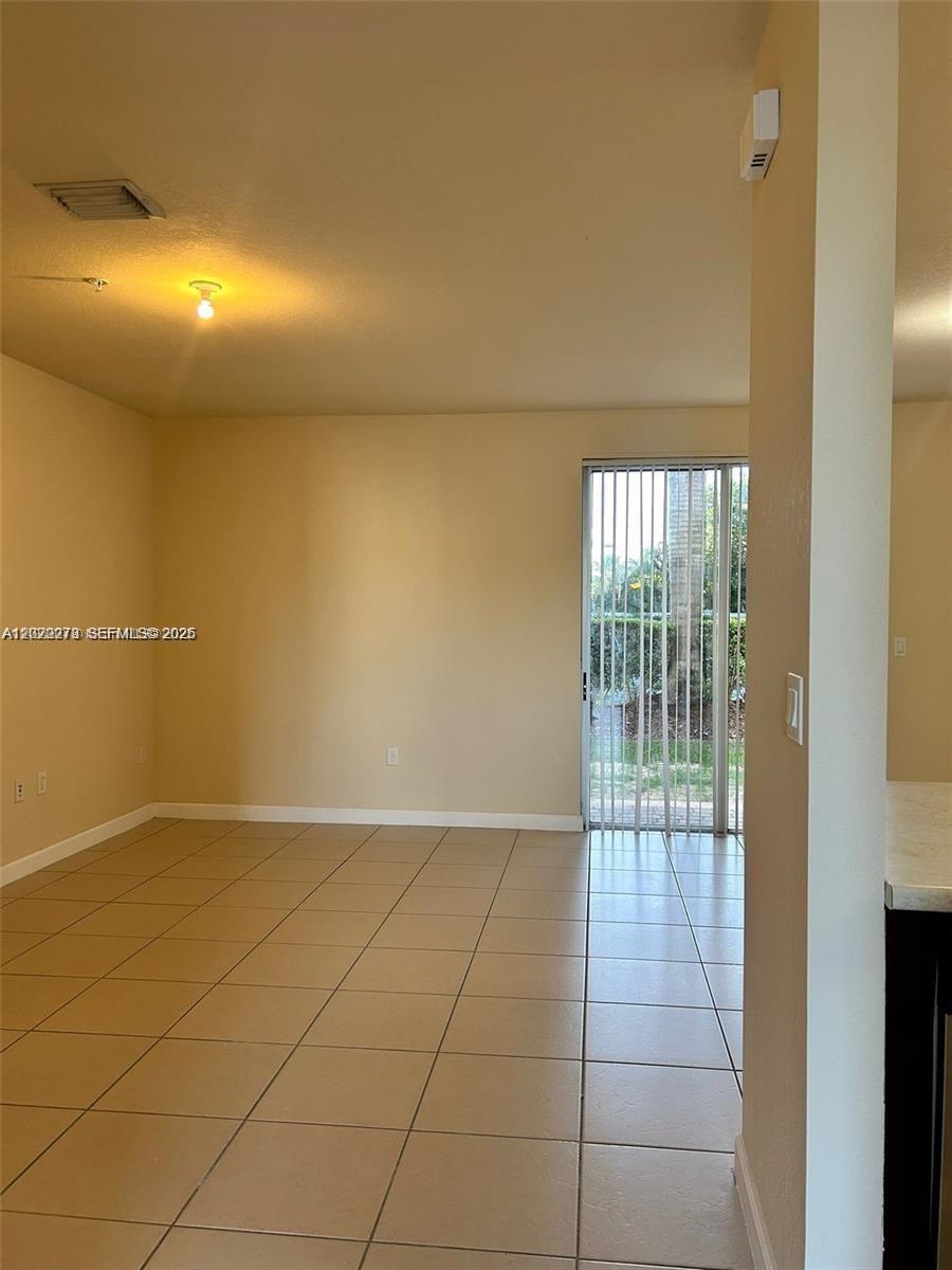 142 Northeast 28th Terrace, Unit 7 Homestead, FL 33033 - Photo 16 of 17 a view of an empty room and window