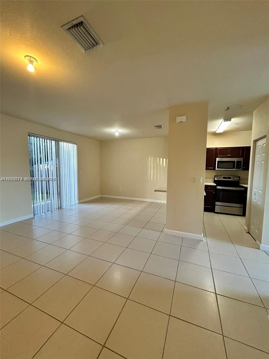 142 Northeast 28th Terrace, Unit 7 Homestead, FL 33033 - Photo 17 of 17 a view of a livingroom with furniture