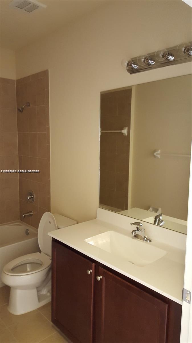 142 Northeast 28th Terrace, Unit 7 Homestead, FL 33033 - Photo 4 of 17 a bathroom with a sink a toilet and shower