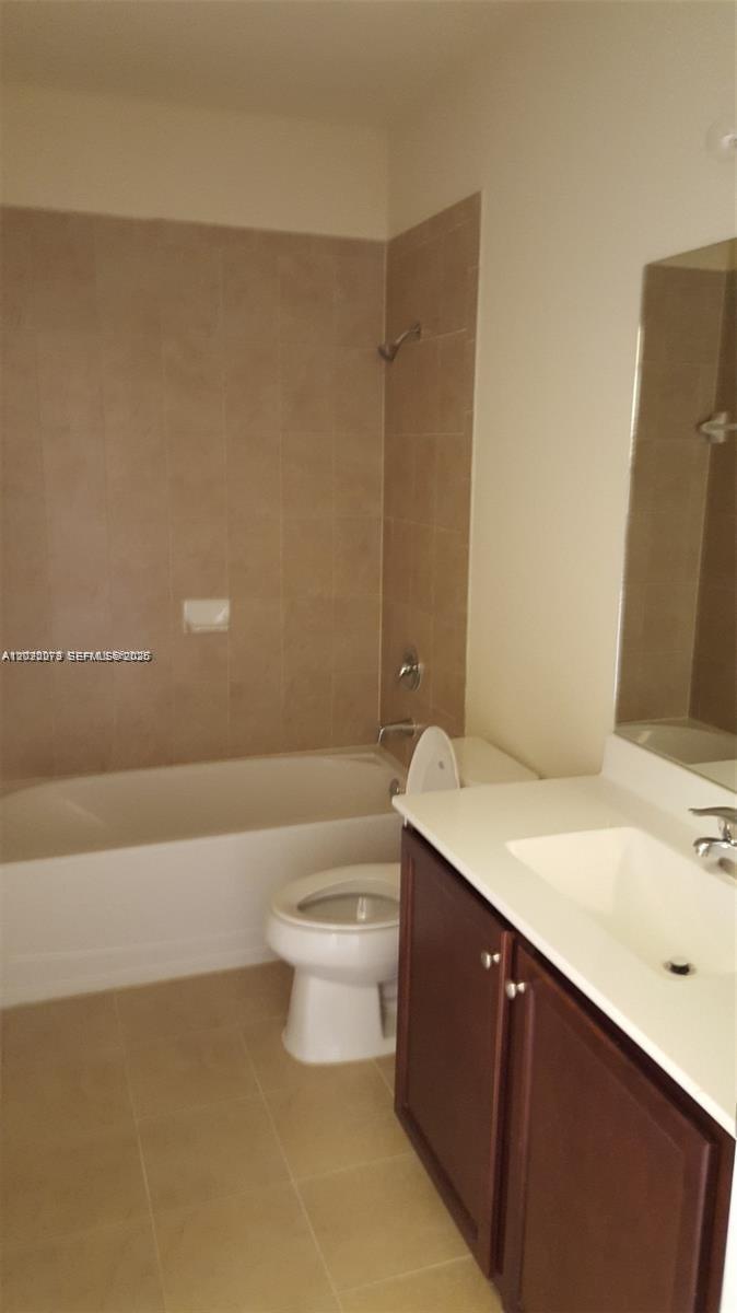 142 Northeast 28th Terrace, Unit 7 Homestead, FL 33033 - Photo 5 of 17 a bathroom with a sink a toilet and shower