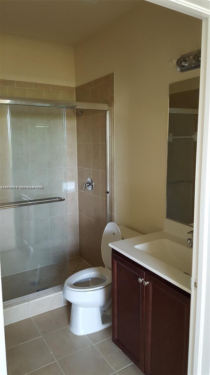 142 Northeast 28th Terrace, Unit 7 Homestead, FL 33033 - Photo 6 of 17 a bathroom with a sink a toilet and shower