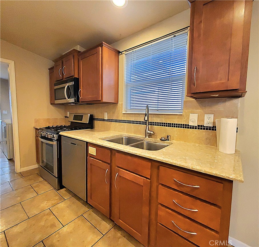 21621 Sandia Road, Unit 127 Apple Valley, CA 92308 - Photo 12 of 43 a kitchen with stainless steel appliances granite countertop a sink stove and cabinets