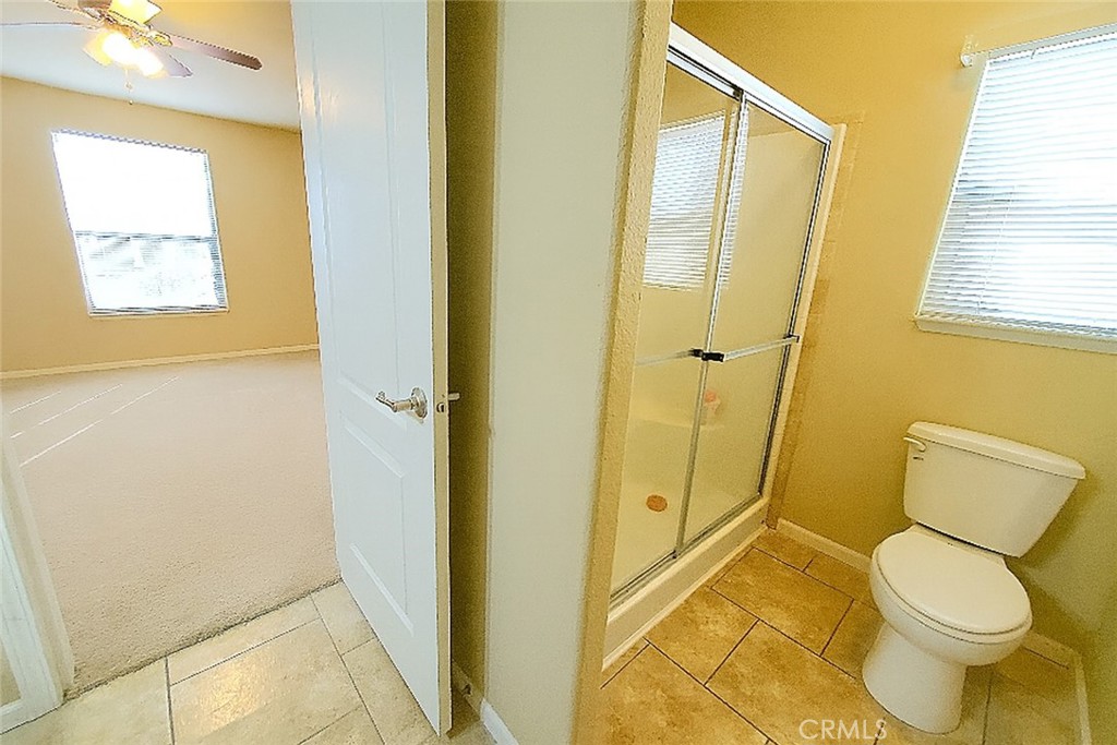 21621 Sandia Road, Unit 127 Apple Valley, CA 92308 - Photo 19 of 43 a bathroom with a toilet and a shower