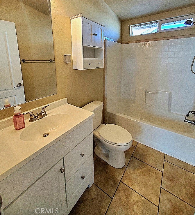 21621 Sandia Road, Unit 127 Apple Valley, CA 92308 - Photo 26 of 43 a bathroom with a toilet sink and mirror