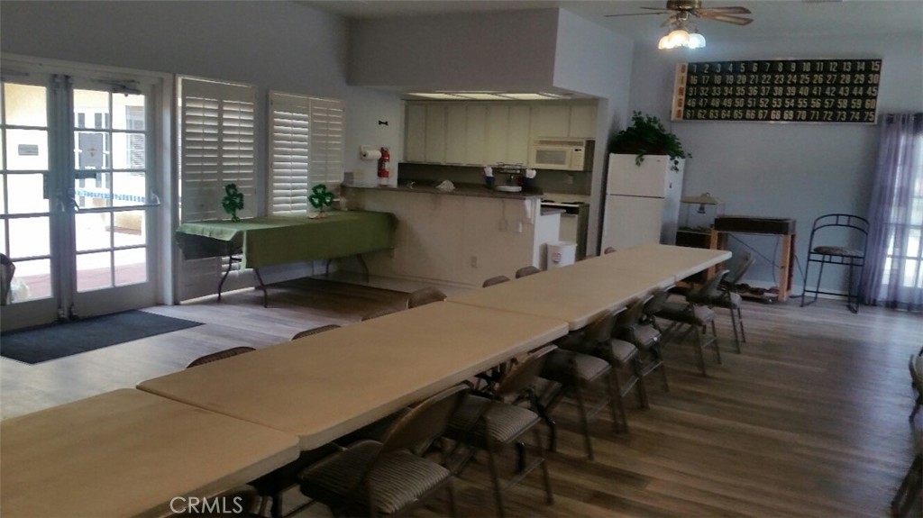 21621 Sandia Road, Unit 127 Apple Valley, CA 92308 - Photo 40 of 43 a dining room with furniture and wooden floor
