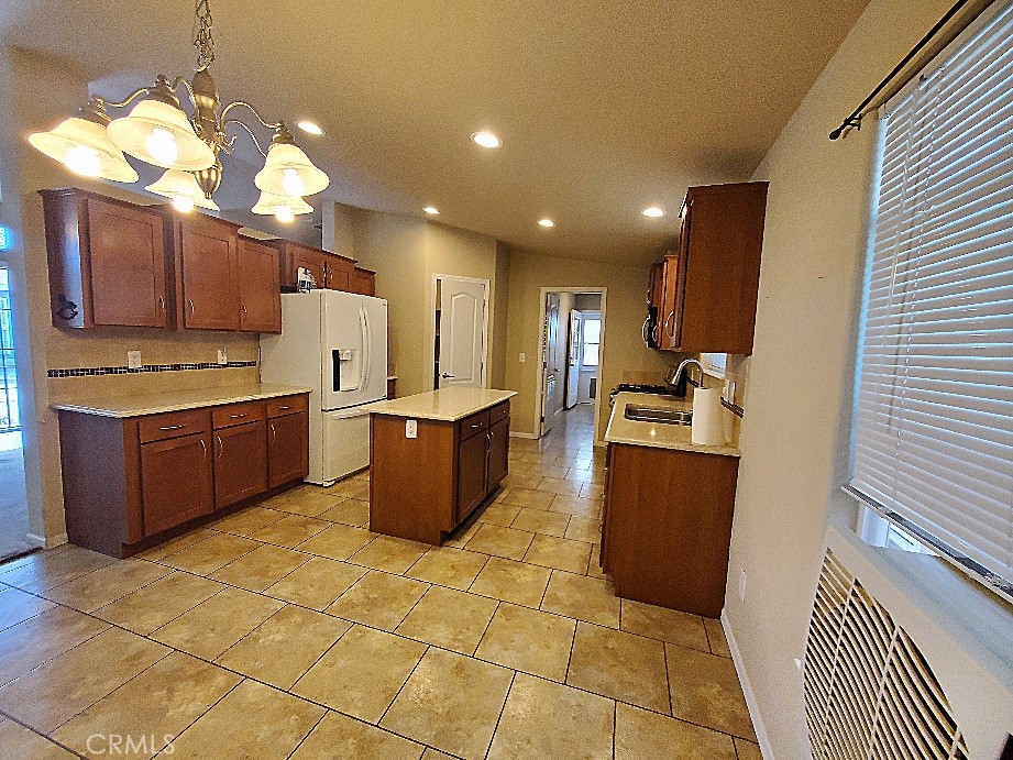 21621 Sandia Road, Unit 127 Apple Valley, CA 92308 - Photo 8 of 43 a kitchen with a sink a counter top space appliances and cabinets