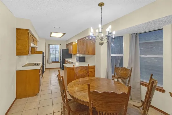 a view of a dining room with furniture and chandelier
